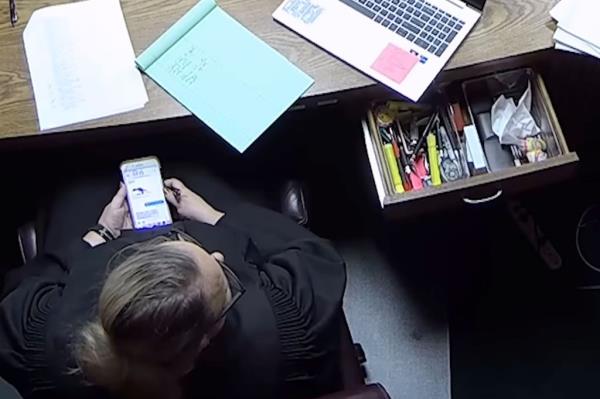 Soderstrom is pictured on her phone during trial.