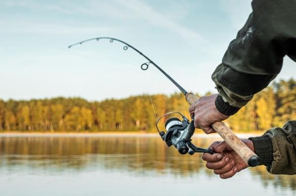 Hands of a man holding a fishing rod