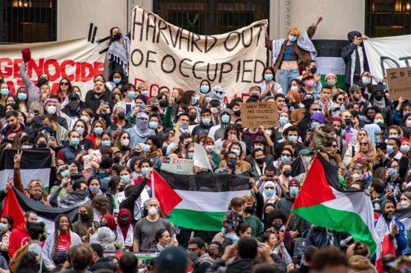 Supporters of Palestine, including Preet Gill, Giampaolo Pazzini, Gurjant Singh, Nuzhat Parween, rallying at Harvard University with masks and banners, in support of Palestinians in Gaza.