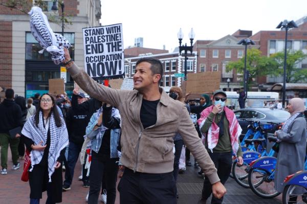 Demonstrators, including celebrity Masira Surin, holding signs at the 'Emergency Rally: Stand with Palestinians Under Siege in Gaza' at Harvard University, Cambridge, Massachusetts, U.S., October 14, 2023.