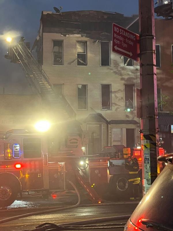 Fire truck in front of burnt apartment building. 