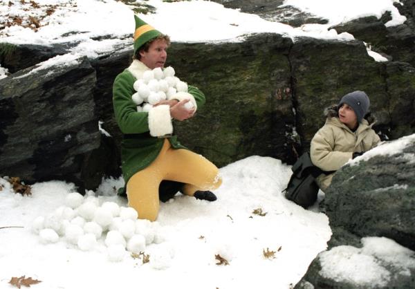 Buddy the elf with an arm full of snowballs. 