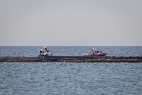 Chicago Police Department Marine Unit officers investigate the scene.