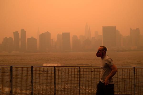 The New York City Manhattan skyline as seen from the East River in Long Island City covered in haze and smoke caused by wildfires in Canada on June 7, 2023.