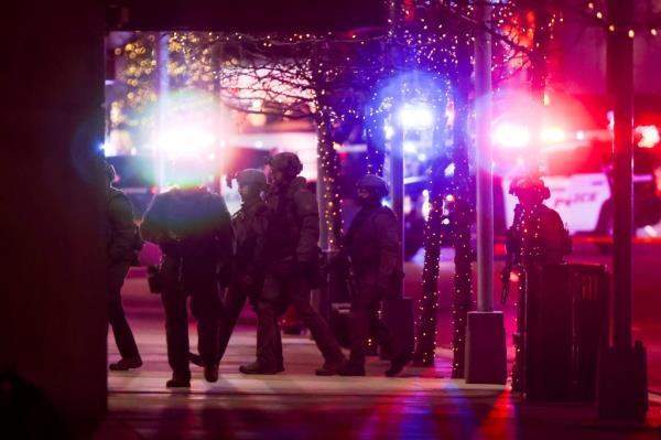 Police SWAT team members walk through the Belmar shopping center wher<em></em>e authorities say the suspect in a shooting spree that claimed five lives was shot and killed on December 27, 2021 in Lakewood, Colorado.
