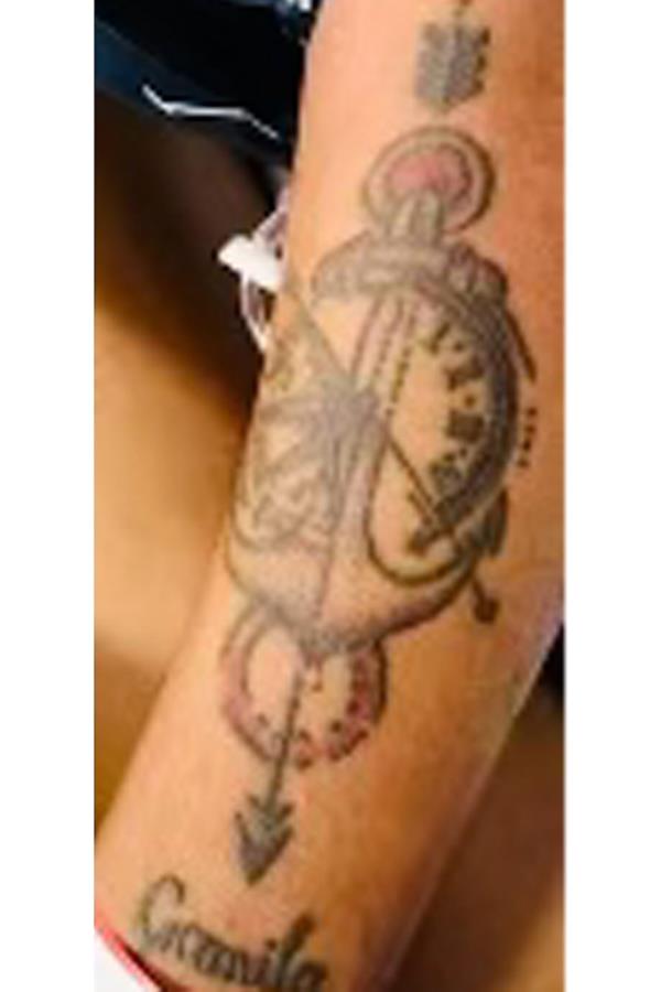 One of Tren de Aragua's tattoos of a clock is seen on the arm of cop shooting suspect Bernardo Castro Mata.