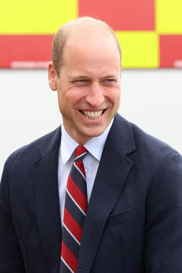 Prince William, Duke of Cambridge, laughing while speaking to RAF perso<em></em>nnel after a fire respo<em></em>nse simulation in Anglesey, North Wales