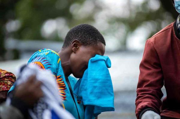 The relative of a victim of the Mpo<em></em>ndwe Lhubiriha Seco<em></em>ndary School mourns outside the Bwera General Hospital Mortuary.