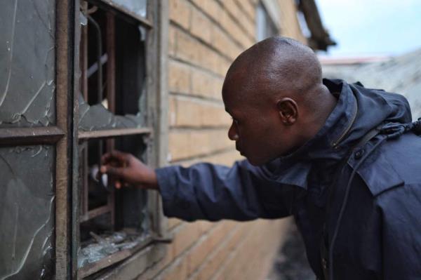 Uganda security forces are seen at the premises of an attack in Mpondwe, Uganda, on June 18.