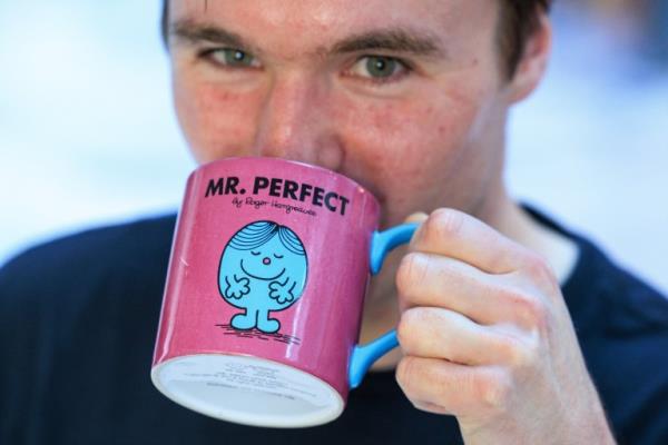 tom drinking out of mug