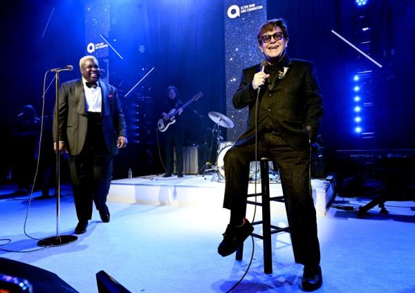 Elton John wearing his kneecap necklace.