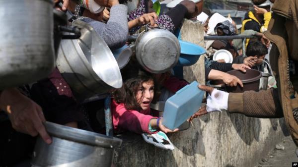 FILE - Palestinians line up for free food during the o<em></em>ngoing Israeli air and ground offensive on the Gaza Strip in Rafah, Jan. 9, 2024.