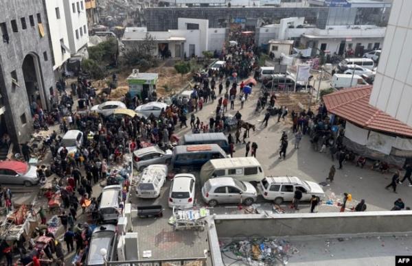 FILE - Displaced Palestinians gather in the yard of Gaza's Al-Shifa hospital, Dec. 10, 2023.
