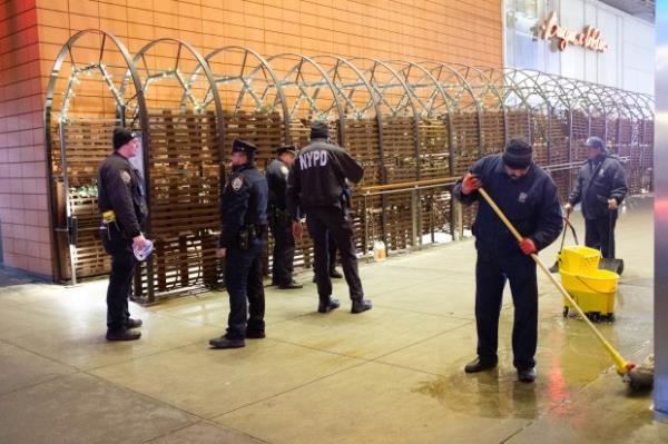 Workers mop up blood as police investigate a stabbing on West 43rd Street and 7th Avenue in Times Square, Manhattan, New York City on Tuesday, Jan. 23, 2024. (Gardiner Anderson for New York Daily News)