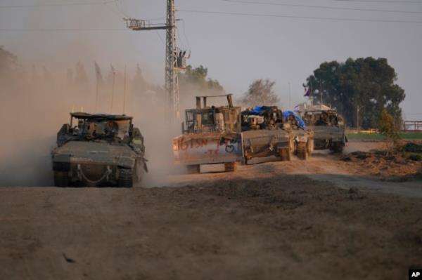 A column of armored Israeli army vehicles drives in southern Israel near the Gaza border on Feb. 16, 2024.