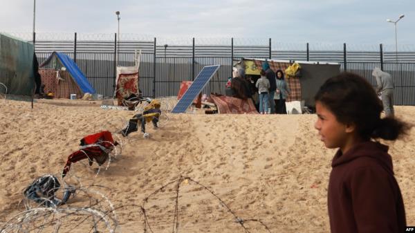 Displaced Palestinians camp near the border fence between Gaza and Egypt on Feb. 16, 2024, in Rafah, in the southern Gaza Strip.