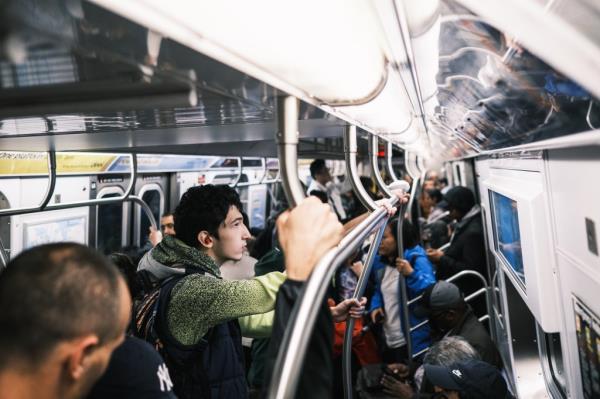 Straphangers back o<em></em>nto a subway train in September. 