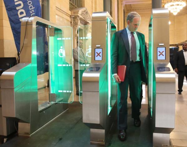 MTA chairman Janno Lieber checks out a new fare gate model that's been widely adopted by the metro system and railroads in Paris, which is much harder to jump than the current setup used by the MTA but is smart enough to allow those with bikes, strollers or in wheelchairs to pass through much more easily. 