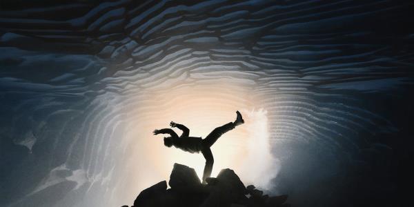 A silhouette of a man dancing in salt mines on The End poster